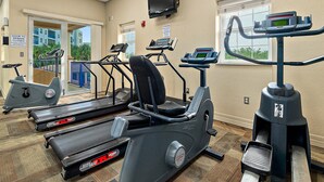 A fitness center with treadmills, elliptical machines, and a stationary bike. - Oceanwalk 16-305 (New Smyrna Beach)