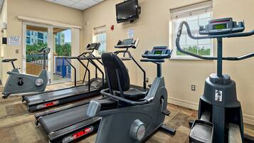 A fitness center with treadmills, elliptical machines, and a stationary bike.