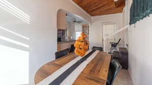 A dining area with a wooden table, black chairs, and a ceiling fan. - Cozy 3Bed only 4min from tufts-10min from downtown Boston (Medford)