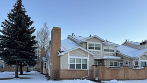 A residential building with a brick facade, multiple windows, and a snow-covered roof. - Serene 3-bedroom townhome in welcoming Evanston perfect for relaxing. (Evanston)