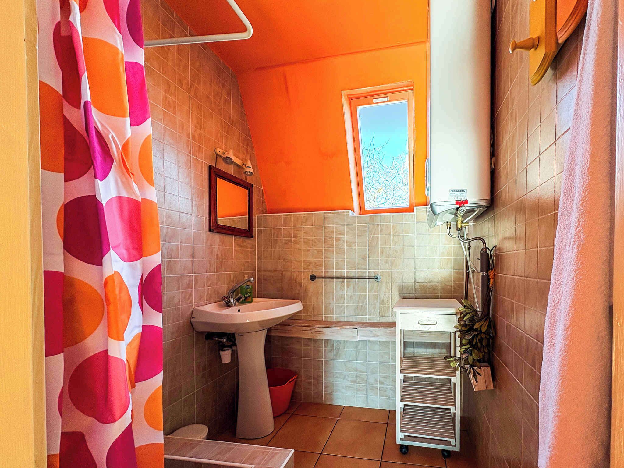 A bathroom with a sink, toilet, and shower curtain.