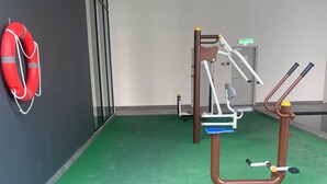 A fitness area with exercise equipment, a lifebuoy, and a door labeled "KELUAR 2". - becentral residence i-city (Shah Alam)