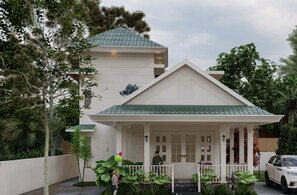 A modern two-story house with a green roof, a porch with a white railing, and a car parked in the driveway. - Bougainvilla Luxury Villa Near IIMK & NIT Calicut (Karanthur)