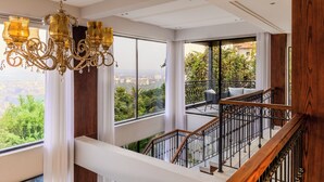 A spacious balcony with a view of greenery and a cityscape. - ELIVAAS Valley View 5BHK Villa With Pool (Mapusa)