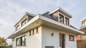 A modern two-story house with a flat roof, large windows, and a visible number '2' on the facade. - Luxury holiday home by the sea (Middelkerke)