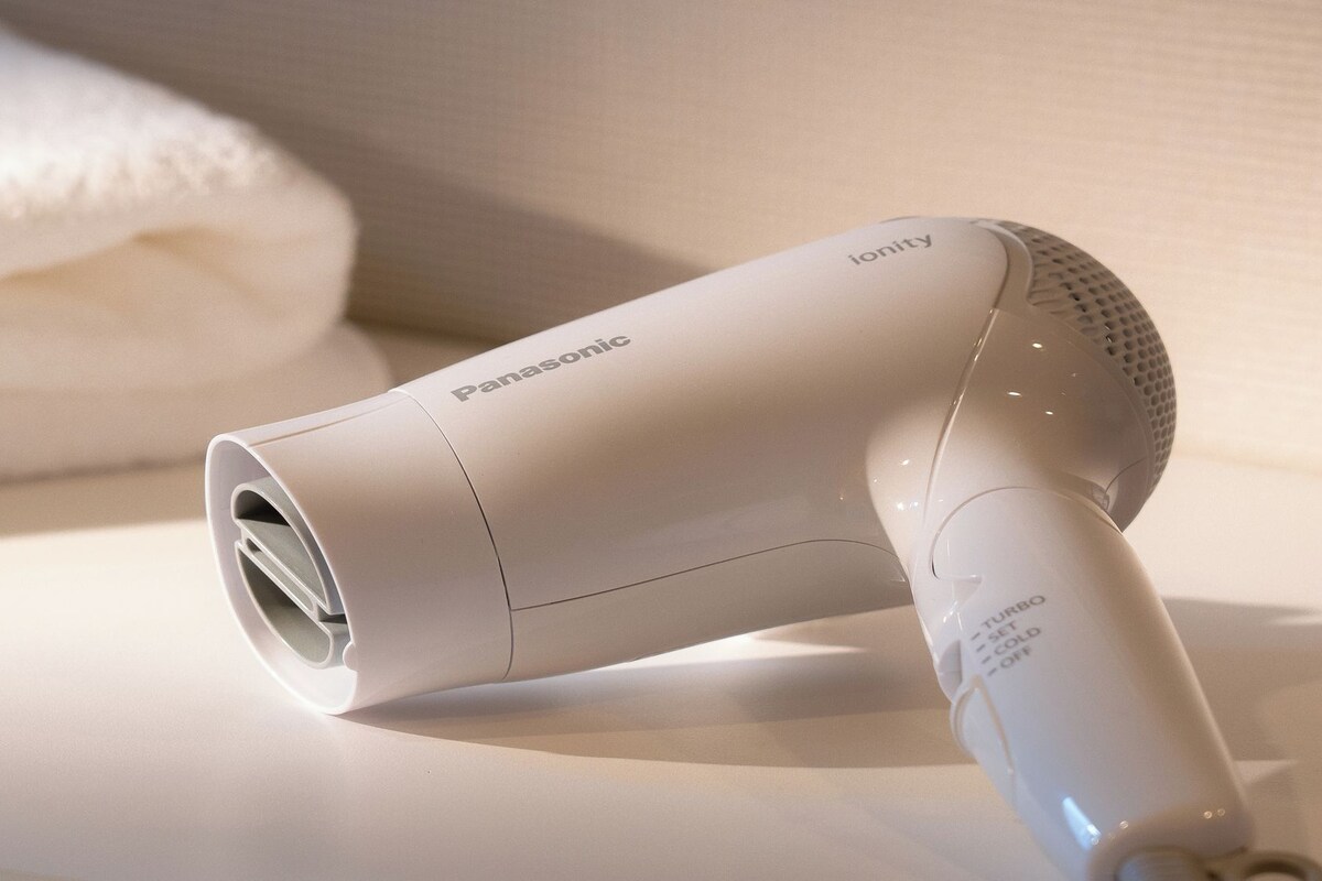 Combined shower/bathtub, hair dryer, slippers, towels