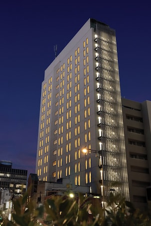 A high-rise building with multiple floors and numerous windows, likely a hotel or office building.