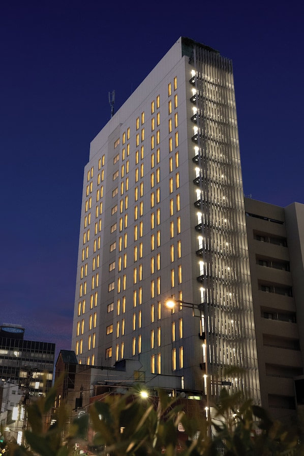 A high-rise building with multiple floors and numerous windows, likely a hotel or office building.
