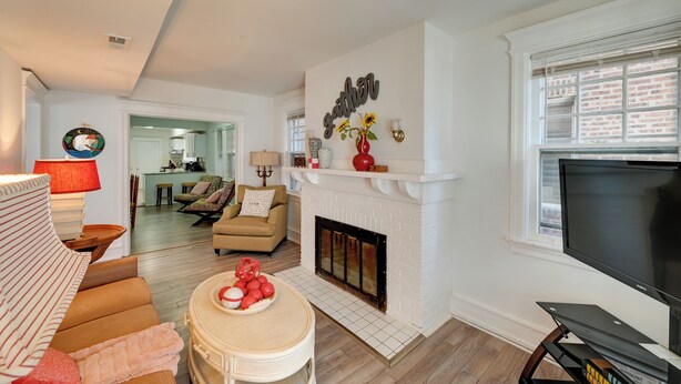 A living room with a fireplace, a television, and a dining area. - 2 Blocks to Beach & Boardwalk: Ventnor City Escape (Ventnor City)