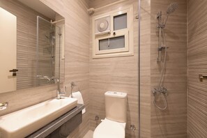 Ein modernes Badezimmer mit einer Duschkabine, einem Waschbecken und einer Toilette.
