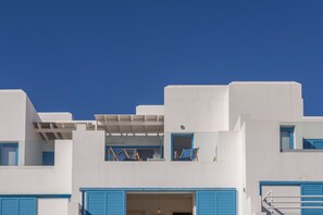 A modern building with white and blue architectural features, including balconies and windows. - Protaras Seafront Villa Galene Del Mar (Protaras)