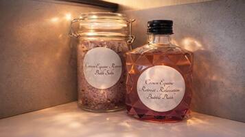 Two containers labeled 'Crown Equine Retreat Relaxation Bubble Bath' on a shelf.