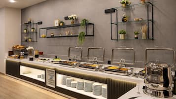 A buffet setup with multiple serving stations, glass shelves with decorative items, and a variety of food options.