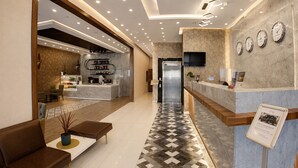 A hotel lobby with a reception desk, seating area, and a coffee bar. - Elite World Inn Istanbul Mahmutbey (Istanbul)