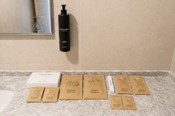 A bathroom counter with toiletries and a shower cap box.