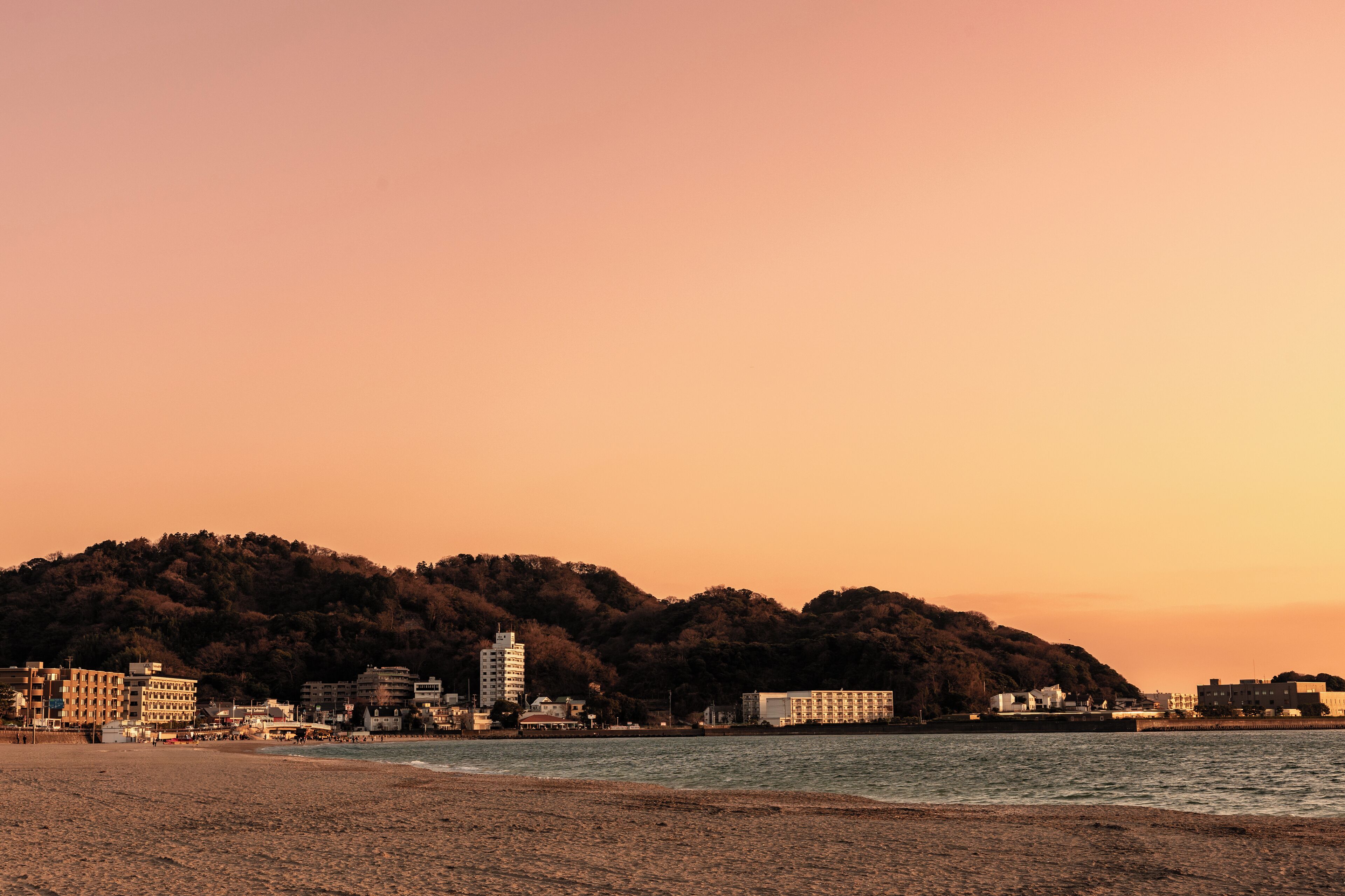 A beach with buildings in the background.