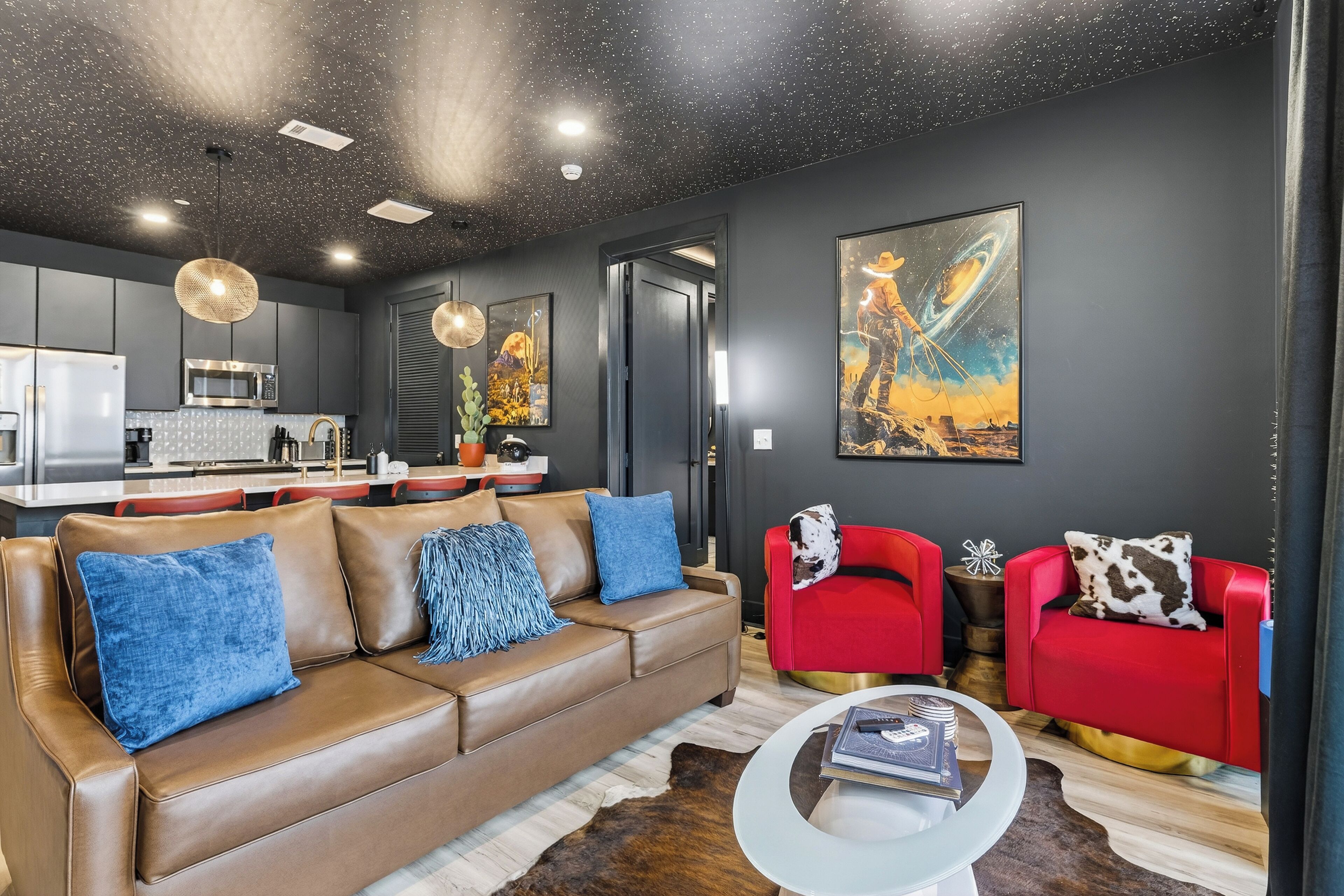 Bold, music-city–inspired living room with plush seating, statement artwork, and an open layout that flows seamlessly into the kitchen.