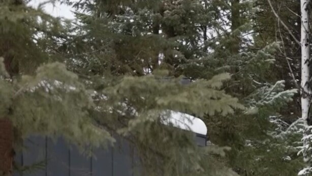 A modern building with large windows and a snow-covered ground. - NEW 9-cabin micro-resort, Full Buy Out-private, 2 hot tubs, 2 saunas,sleeps 24 (Whitefish)
