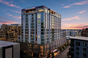 A modern hotel building with a glass facade, multiple floors, and a prominent logo. - Element by Marriott Boise Downtown (Boise)