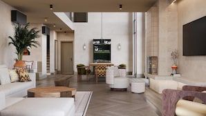 A spacious living area with a high ceiling, a dining table, and seating arrangements. - Beldersoy Resort and Spa, Part of Destination By Hyatt (Chimgan)
