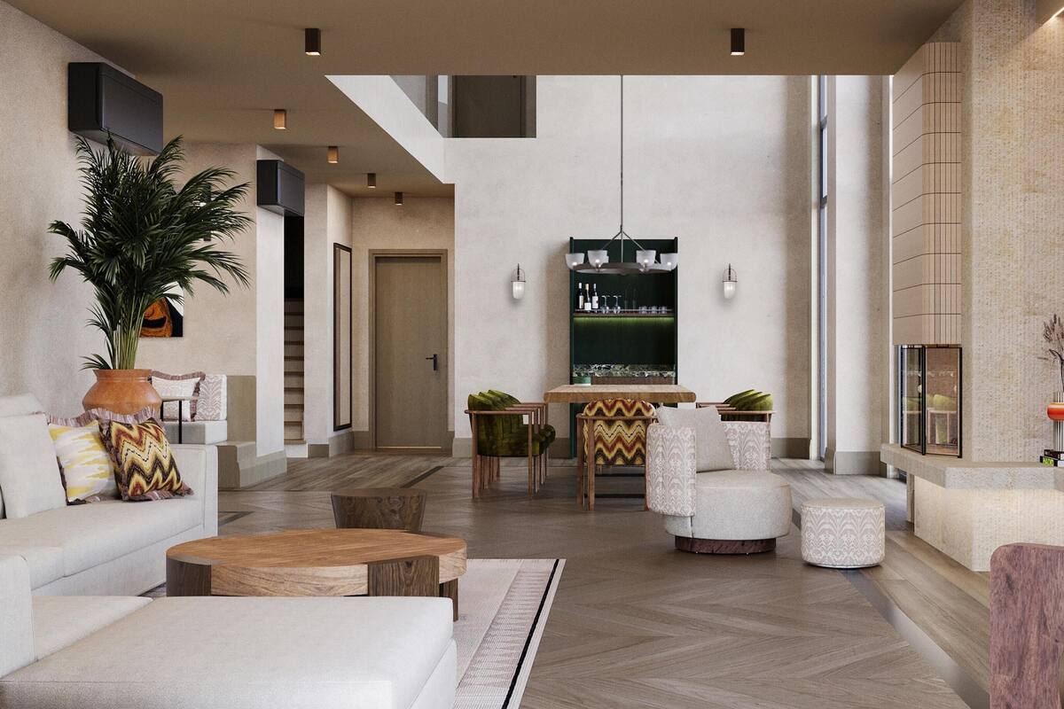 A spacious living area with a high ceiling, a dining table, and seating arrangements.