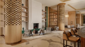A modern lobby with a fireplace, seating area, and a bar. - Beldersoy Resort and Spa, Part of Destination By Hyatt (Chimgan)