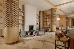 A modern lobby with a fireplace, seating area, and a bar. - Beldersoy Resort and Spa, Part of Destination By Hyatt (Chimgan)