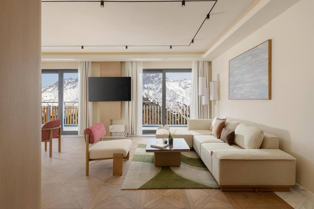 A modern living room with a sofa, a coffee table, and a TV.