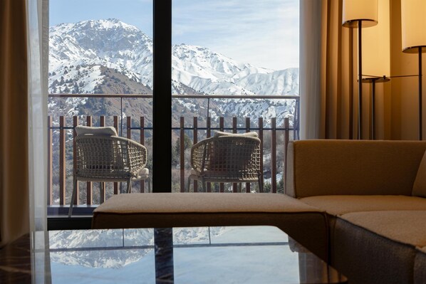 A balcony with two wicker chairs and a sofa, overlooking a snow-covered mountain. - Beldersoy Resort and Spa, Part of Destination By Hyatt (Chimgan)