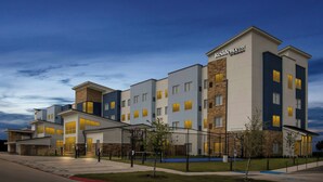 A multi-story hotel with a modern design, featuring a prominent sign for 'Residence Inn by Marriott' on the building facade. - Residence INN BY Marriott Waxahachie (Waxahachie)