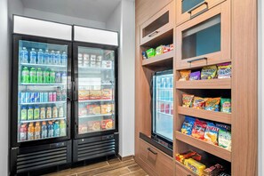 A refrigerated display case with various beverages and snacks.