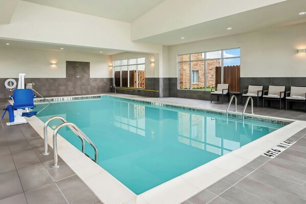 An indoor swimming pool with clear water, a lifeguard chair, and a pool ladder. - Residence INN BY Marriott Waxahachie (Waxahachie)