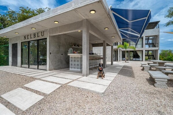 A modern building with a concrete facade and the name "NELBLU" on the entrance. - HOTEL NELBLU #4 - DOUBLE BEDS (Playa Flamingo)