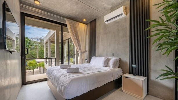 A modern bedroom with a large bed, a bedside table, and a built-in wardrobe. - HOTEL NELBLU #9 - QUEEN DOUBLE BED (Playa Flamingo)