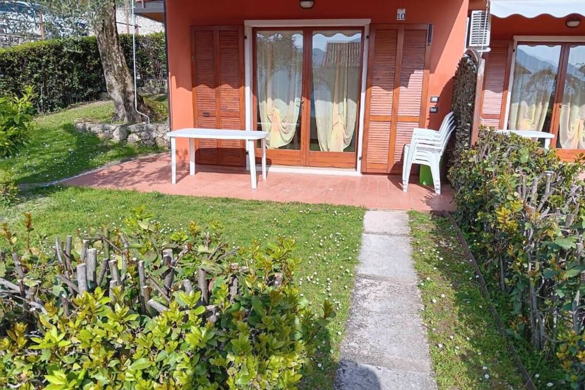 A small building with a patio, a table, and chairs.