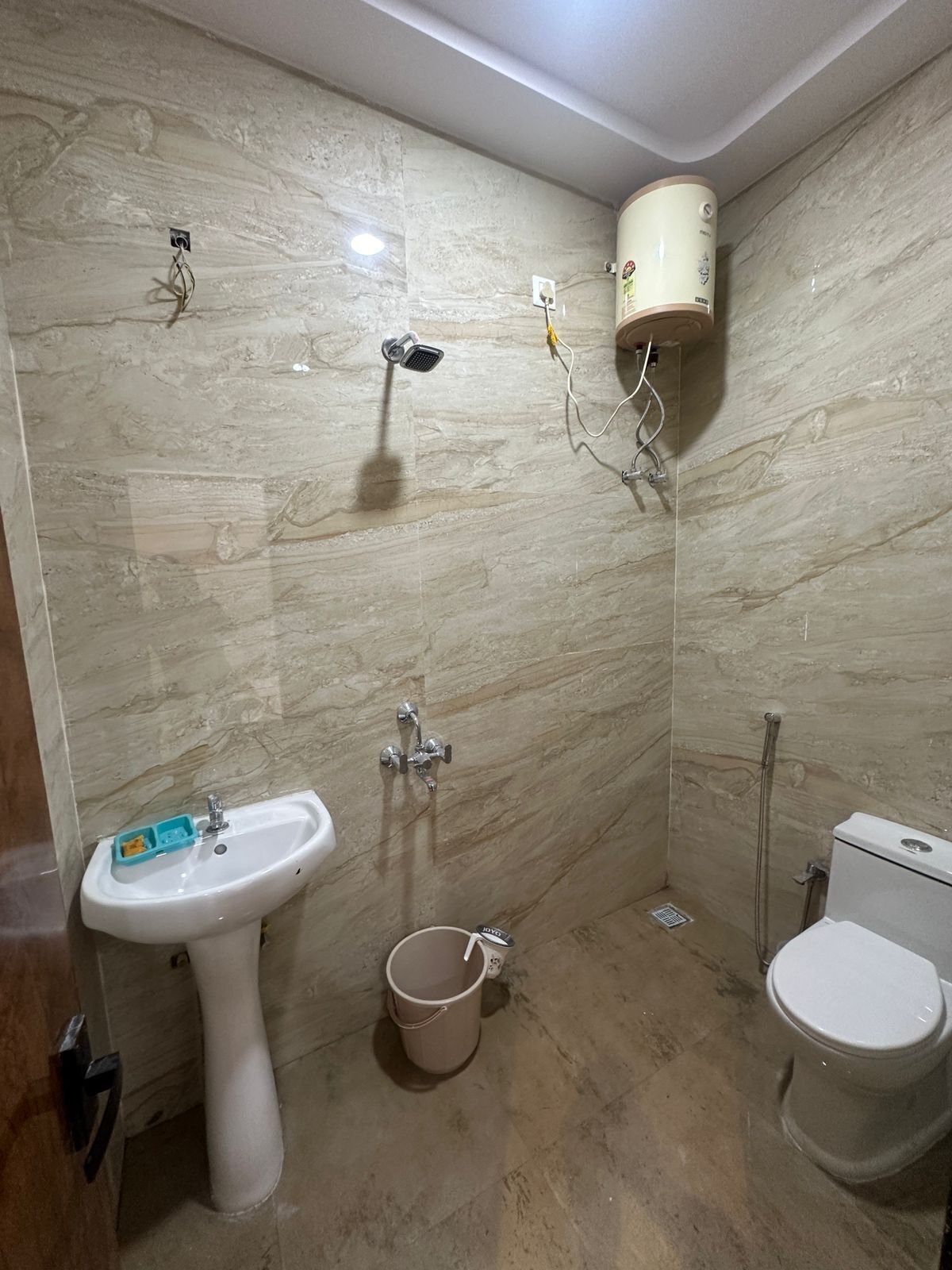 A bathroom with a sink, toilet, and shower.