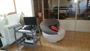 A room with a desk, chair, and a large mirror reflecting the room. - Cabanon provençal: the lezards (sillans la cascade)