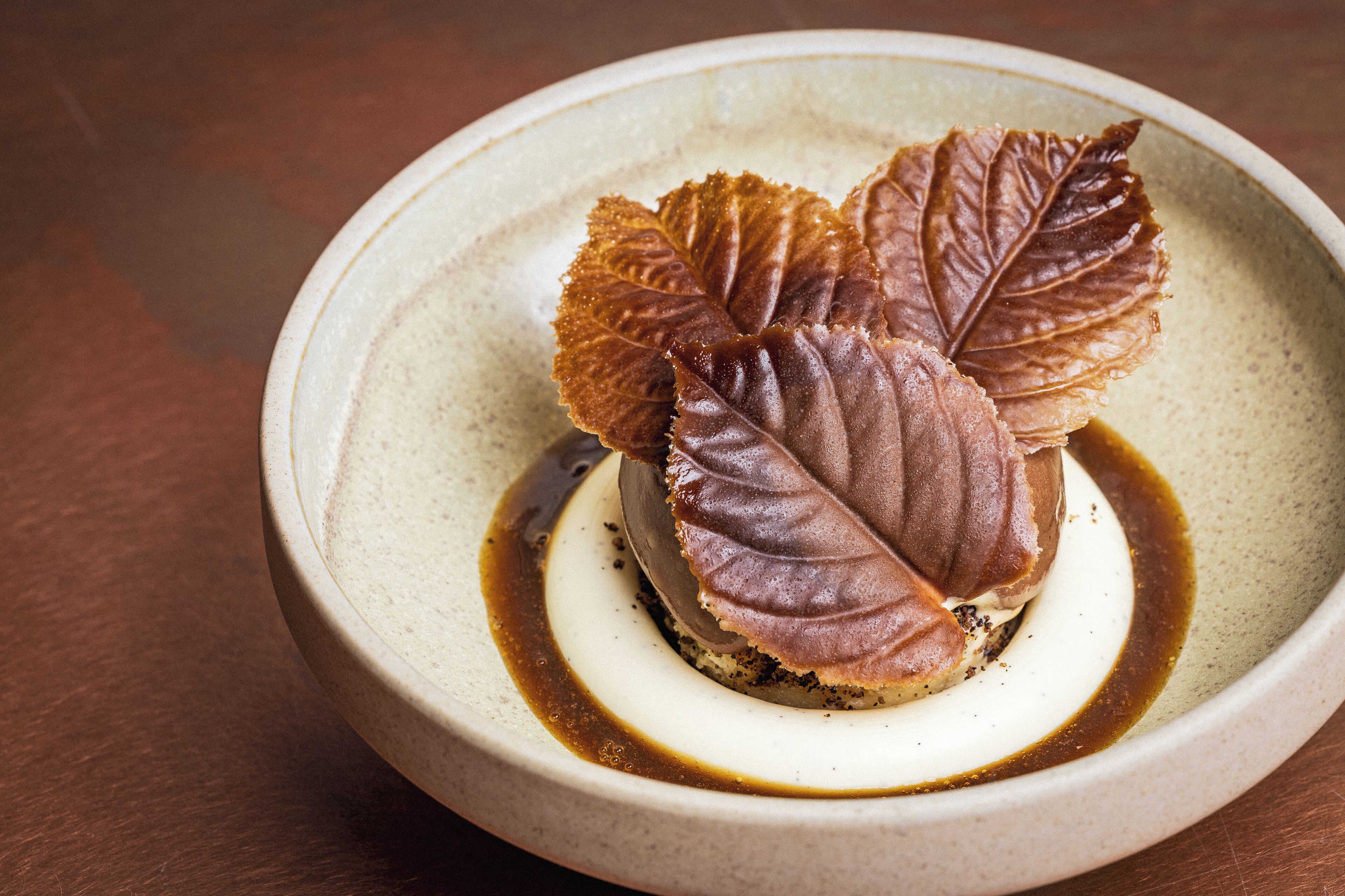 A dessert in a ceramic bowl with a textured surface.