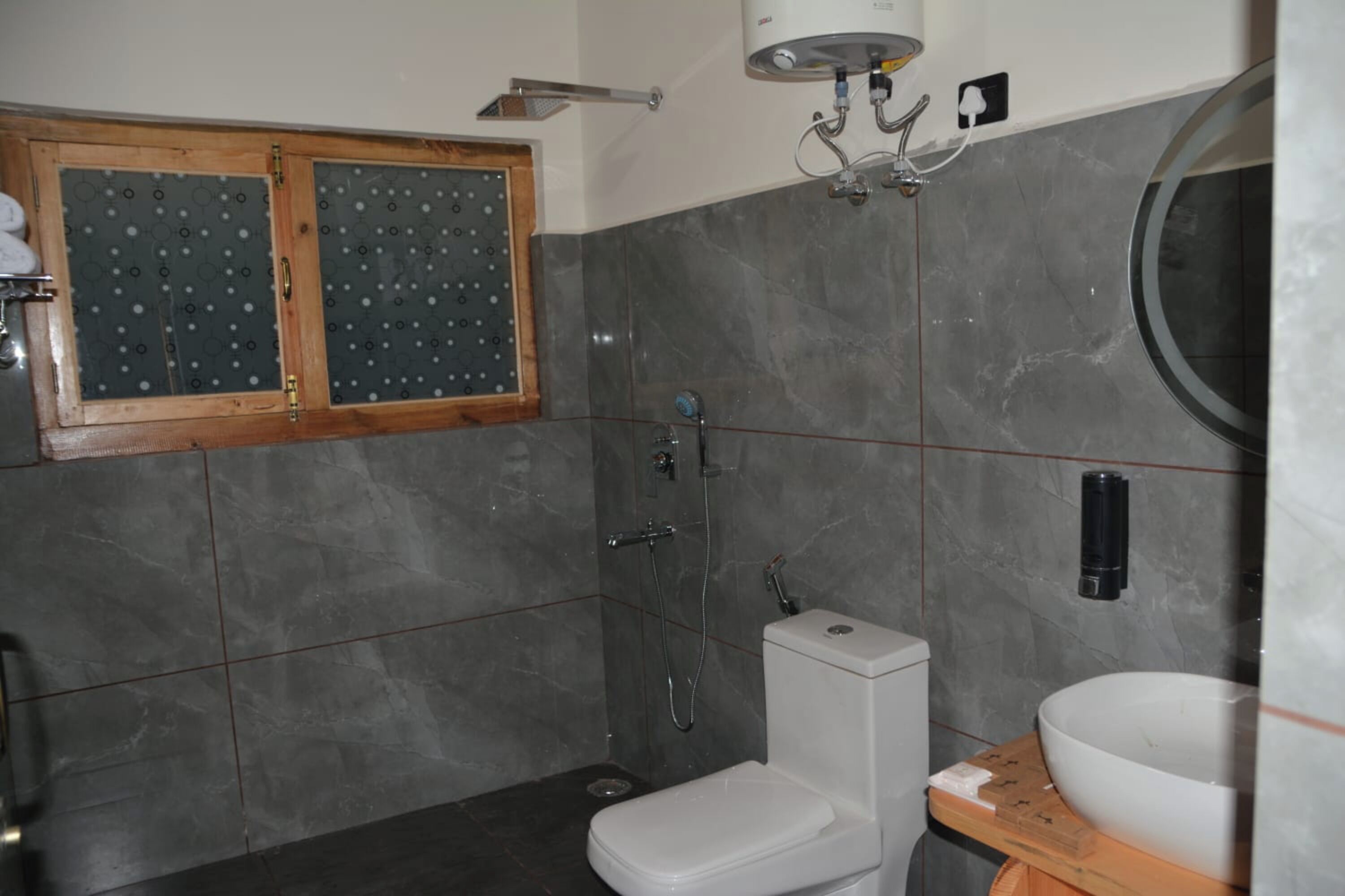 A bathroom with a toilet, a sink, and a shower.