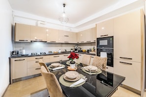 Family Apartment | Private kitchen | Full-size fridge, microwave, cleaning supplies, paper towels - Central Monarh Tower Accomodation (Timișoara)