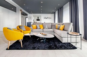 A modern living room with a sectional sofa, a yellow armchair, and a round coffee table. - Villa With Private Pool Near Rovinj (Rovinj)