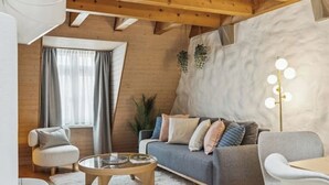 A cozy living room with a sofa, armchairs, a coffee table, and a large window with curtains. - Old Town Riverside | AC | Balcony | Free Parking | Water View (Zürich)