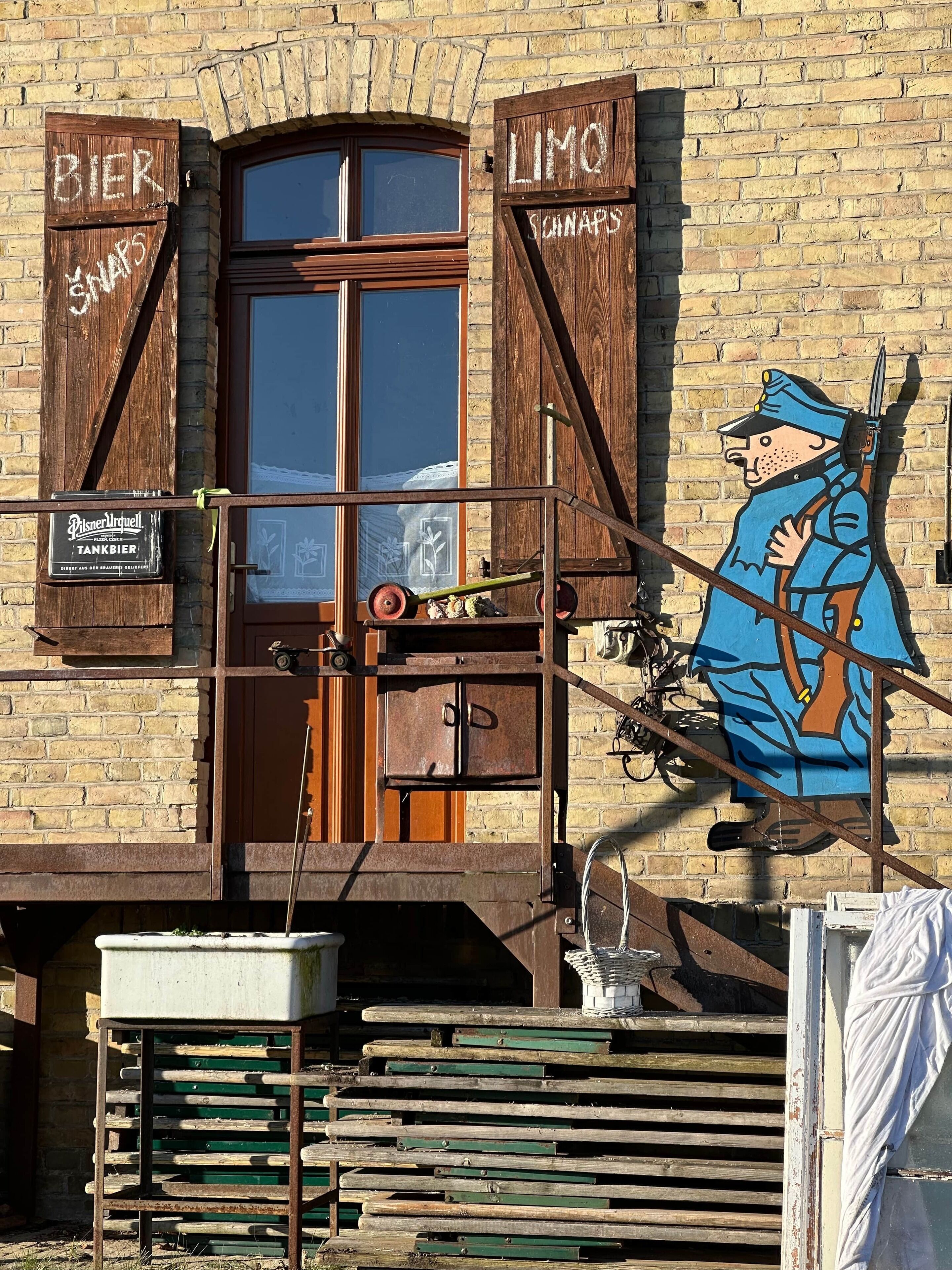 A building with a wooden facade, a large arched window, and a sign indicating it is a beer tap.