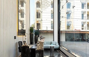 A modern interior with a sofa, a small table, and a chair.