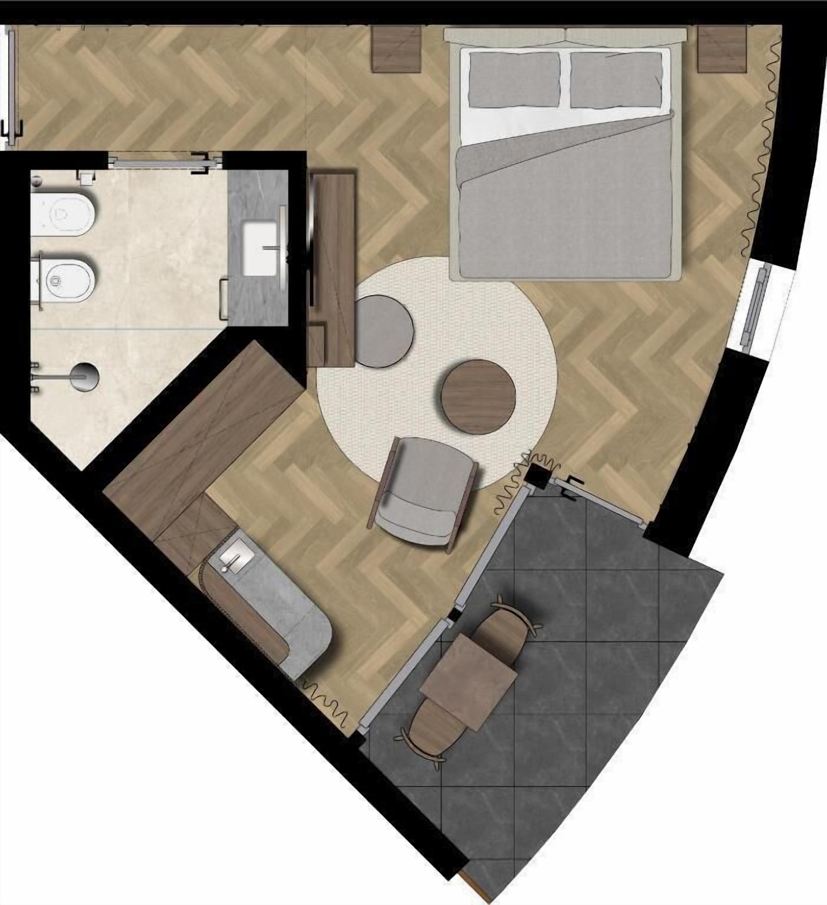 Une chambre d’hôtel comprenant un lit, un coin salon avec une table ronde, une salle de bain séparée et une petite kitchenette.
