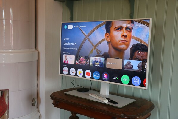 A television displaying a streaming service interface with various app icons.