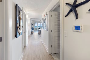 A hallway with a starfish decoration, a thermostat, and framed artwork. - Calypo 3-608 Incredible Home W Exceptional Views. 3Br sleeps 8 (Panama City Beach)