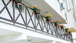A building facade with a series of balconies, each with a metal railing and a flower box. - Modern&Central | WiFi, Coffee, Netflix | GrandStay (Chișinău)