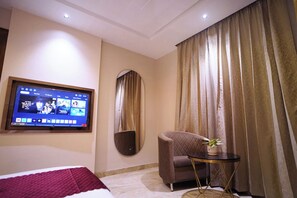 Deluxe Room, City View | Desk, laptop workspace, blackout drapes, iron/ironing board - Trevon Siya Ramaya Inn (Gwalior)