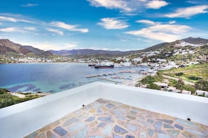 A coastal town with a marina, white buildings, and a clear blue sky.